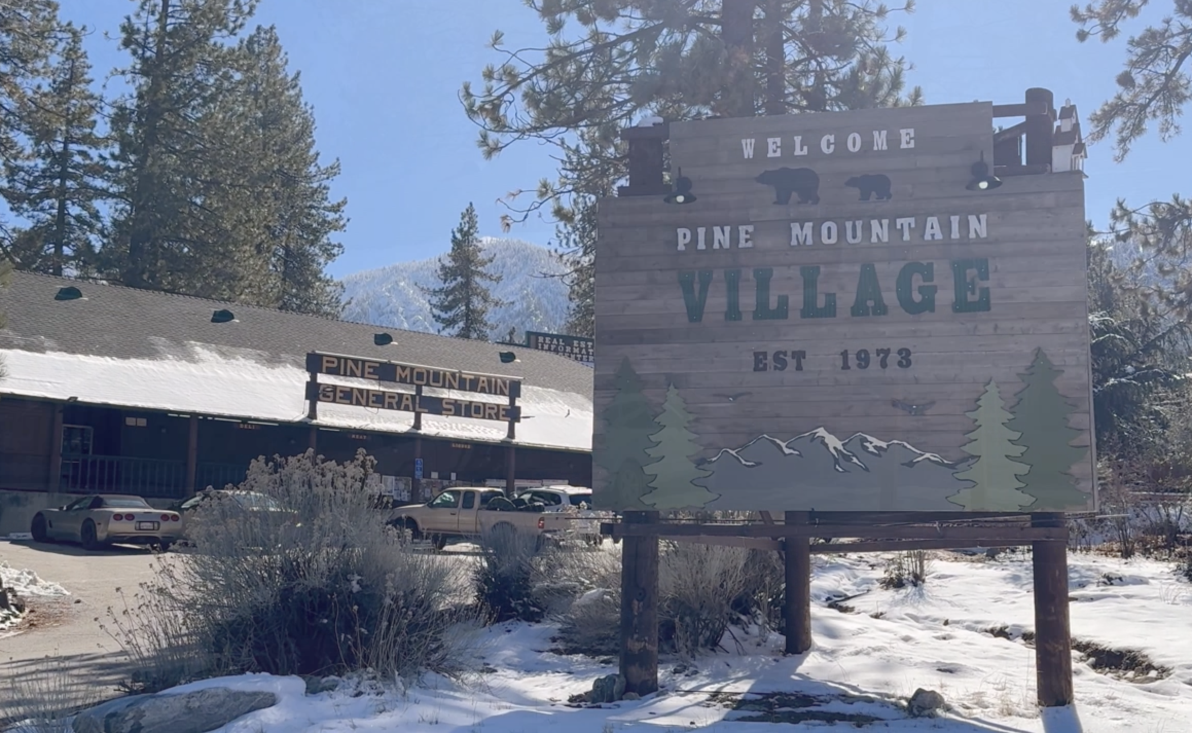 Snowy winter morning at the Pine Mountain Village welcome sign and General Store