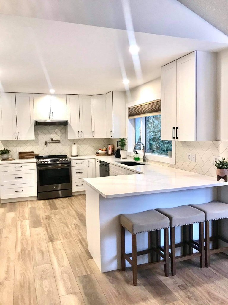 Modern white shaker kitchen with Ply-Spec cabinets and blue herringbone backsplash
