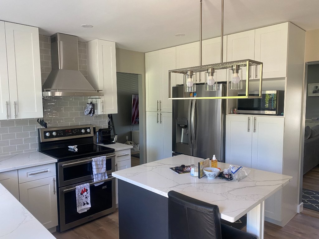 Bright white kitchen with stainless appliances