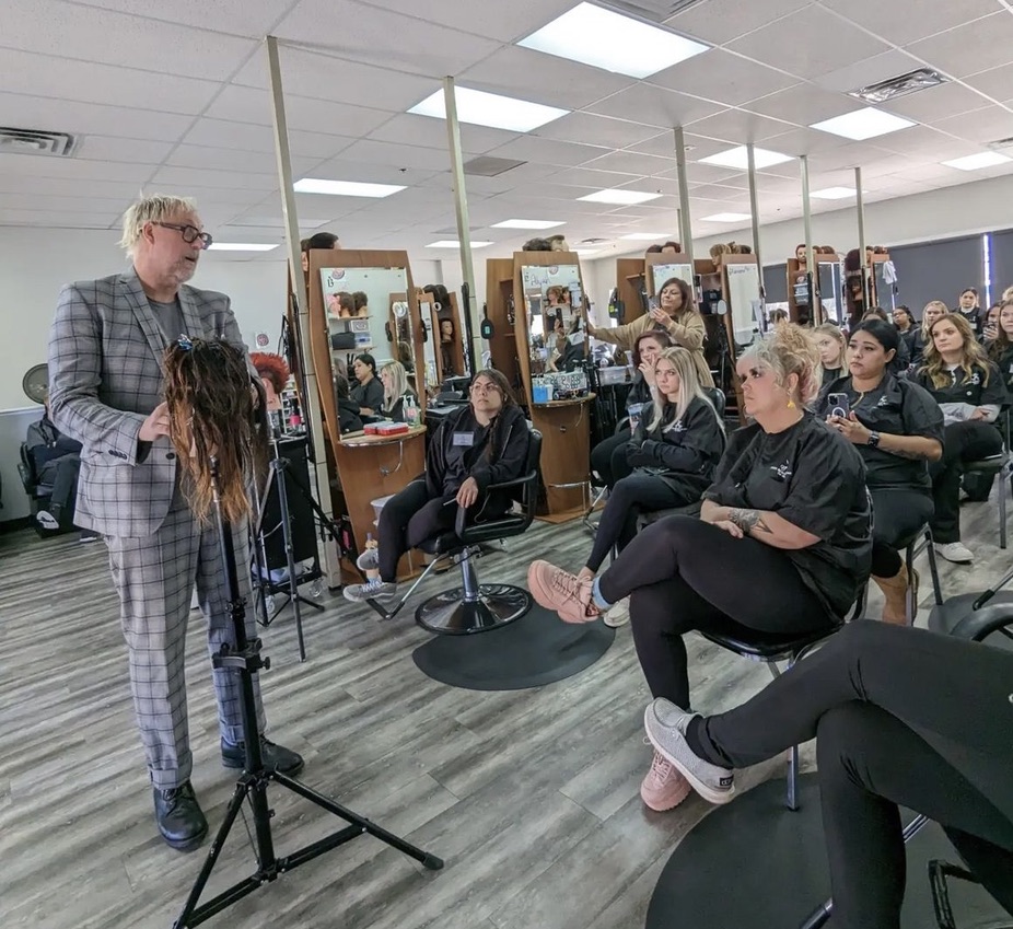 Axcelr8 educator leading a hands-on class for stylists in the academy studio