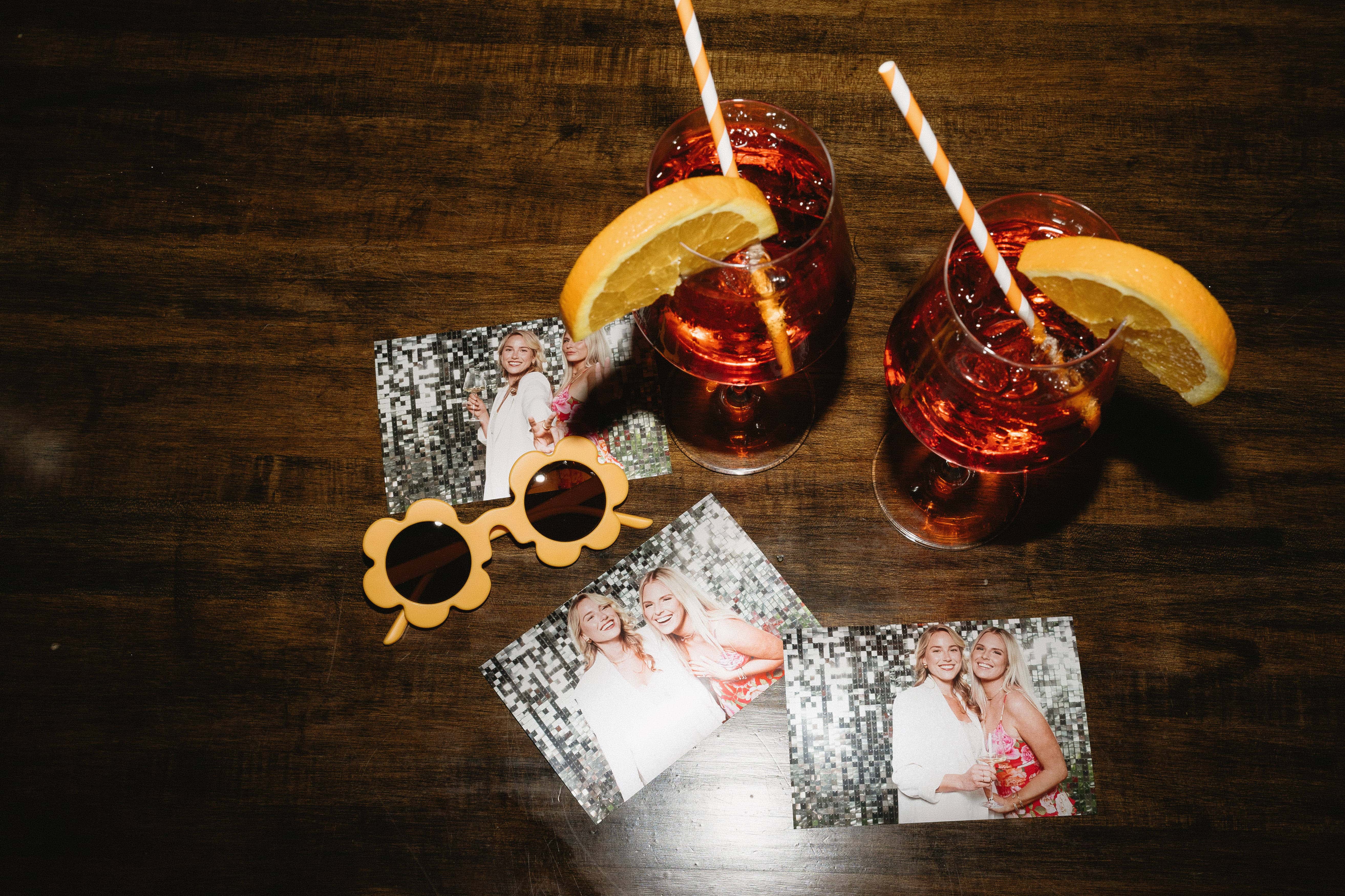 Photo booth prints in hand at a birthday celebration