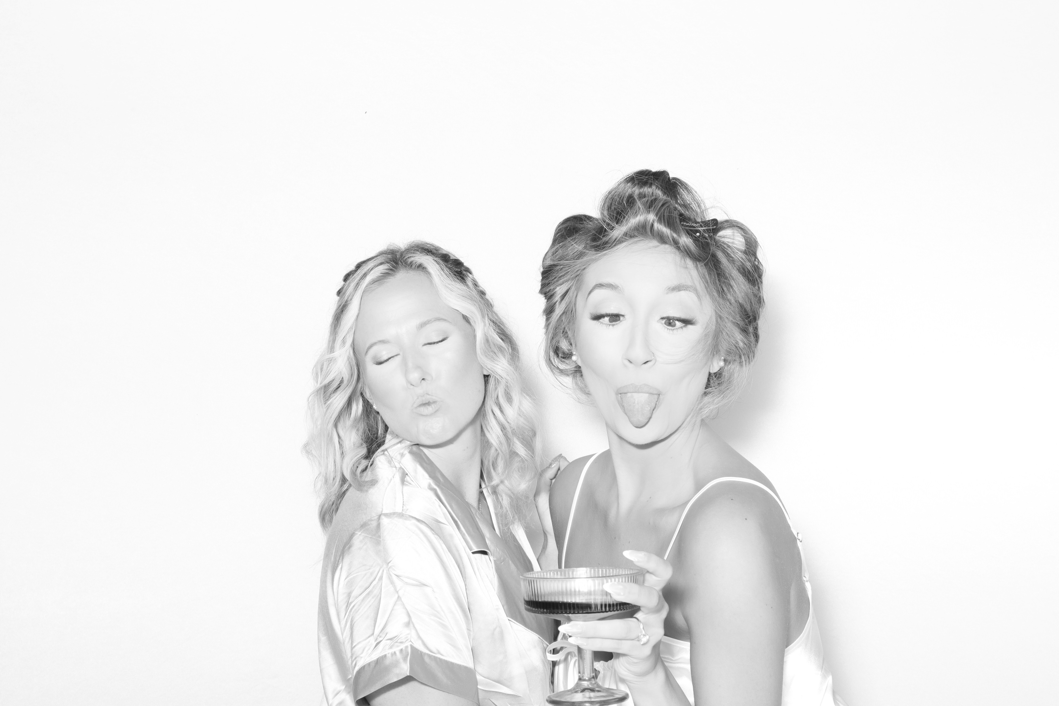 Guests posing together at a photo booth rental during an evening event