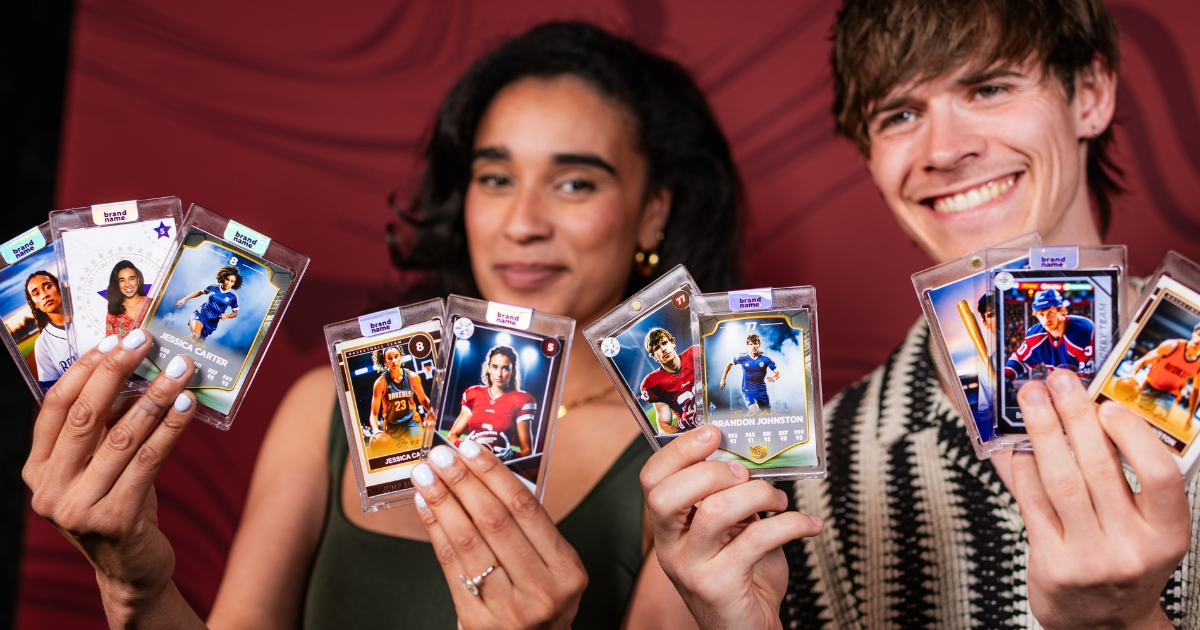 Students holding a fan of custom trading cards encased in protective acrylic holders