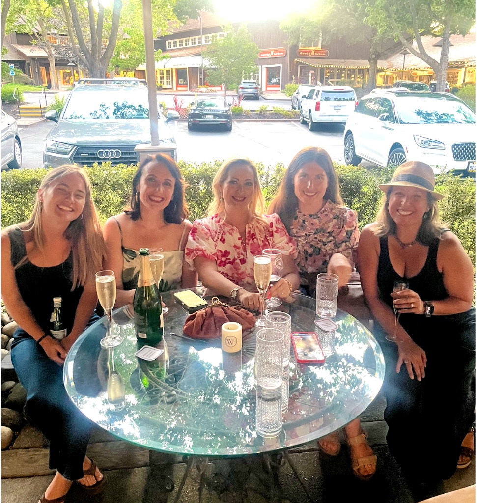 Five women gathered around a table at a She Connects event