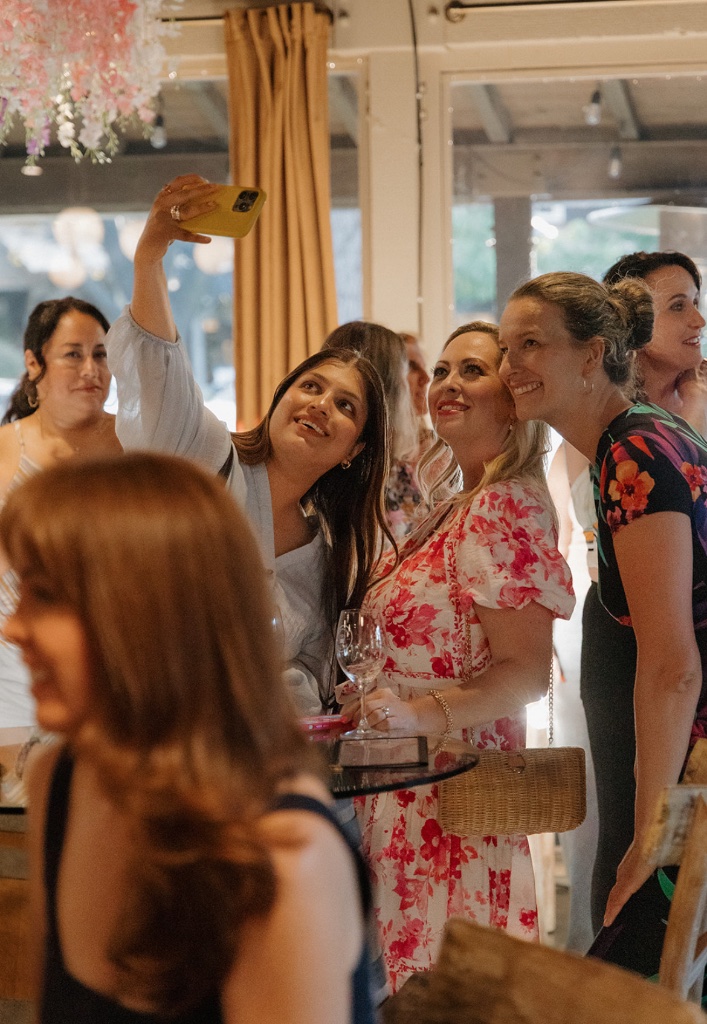 A group of friends taking a selfie together at a community event