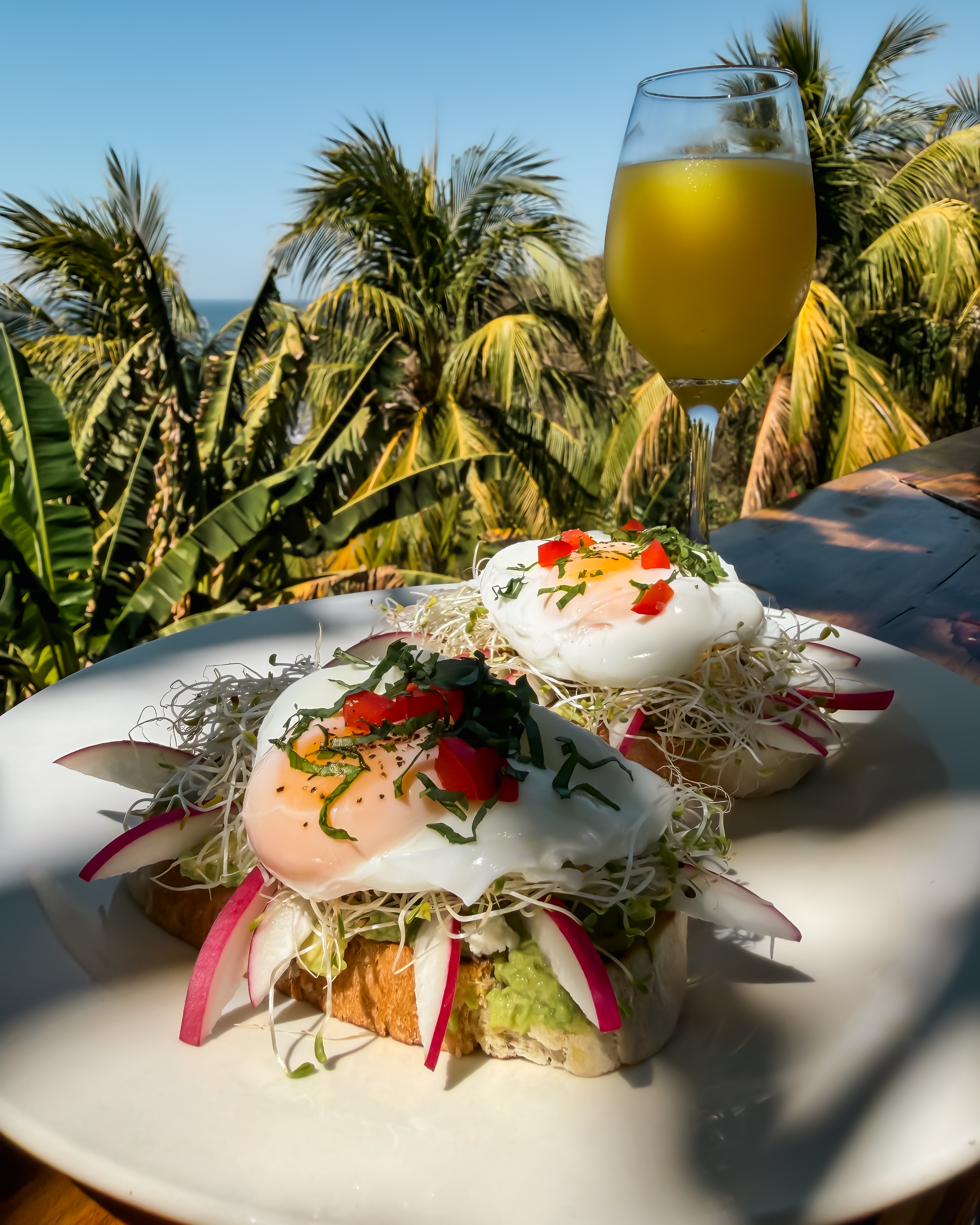 Avocado toast with poached eggs and orange juice