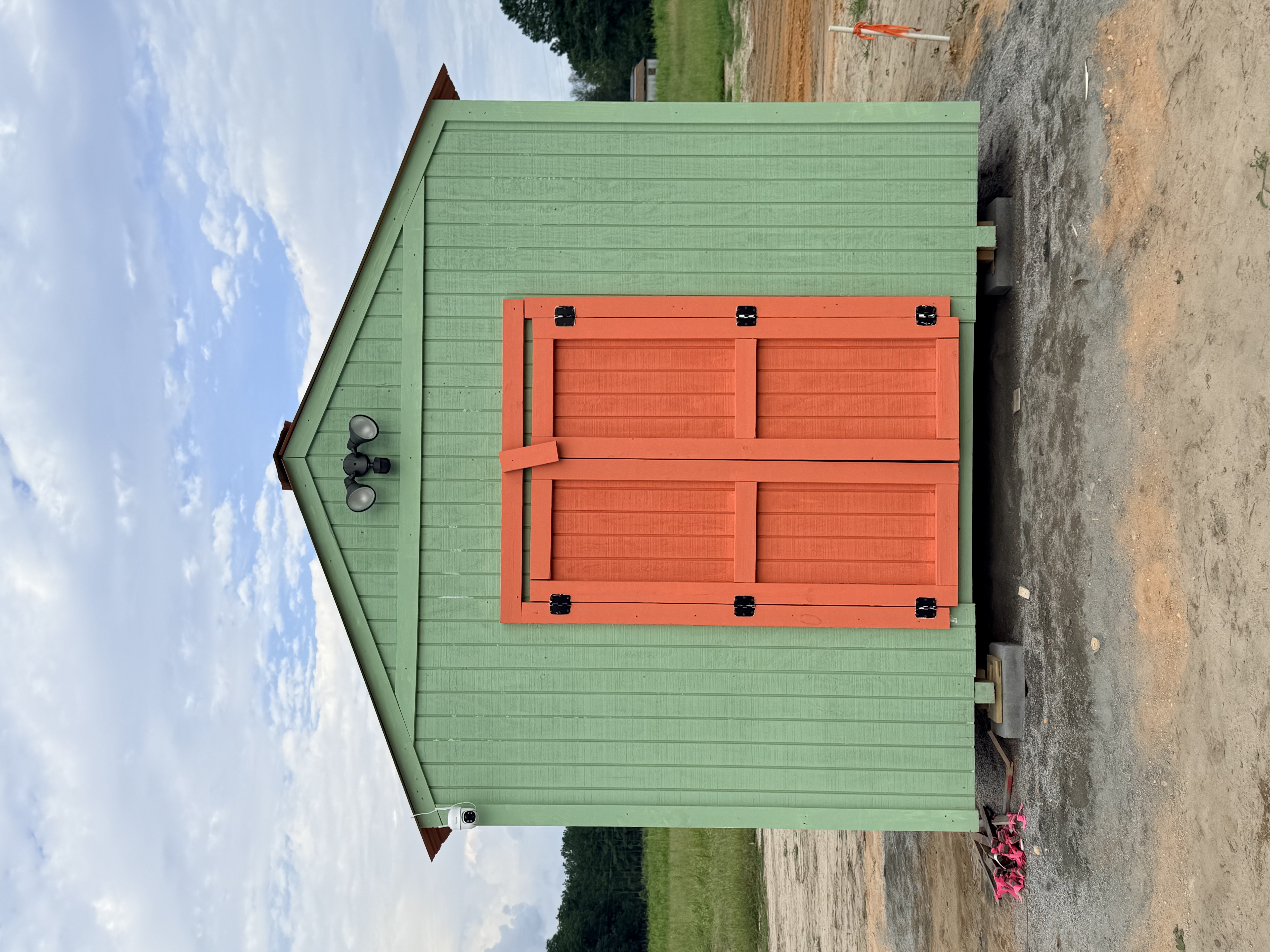 Sage green building housing laundry, vending, and Amazon order pick-up