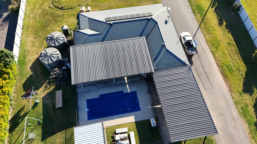 Pristine modern Gold Coast home with sparkling clean driveway and lush tropical landscaping