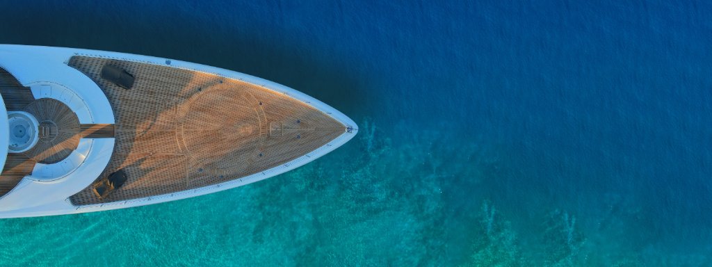 Superyacht bow over turquoise water