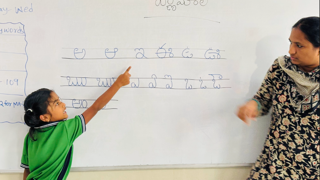 Student at whiteboard with teacher
