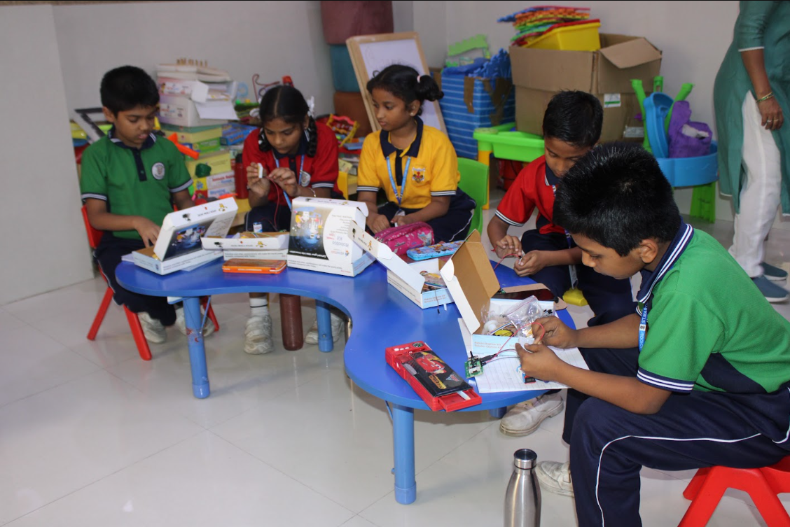 Robotics Workshop — Students Assembling Kits at the Blue Table