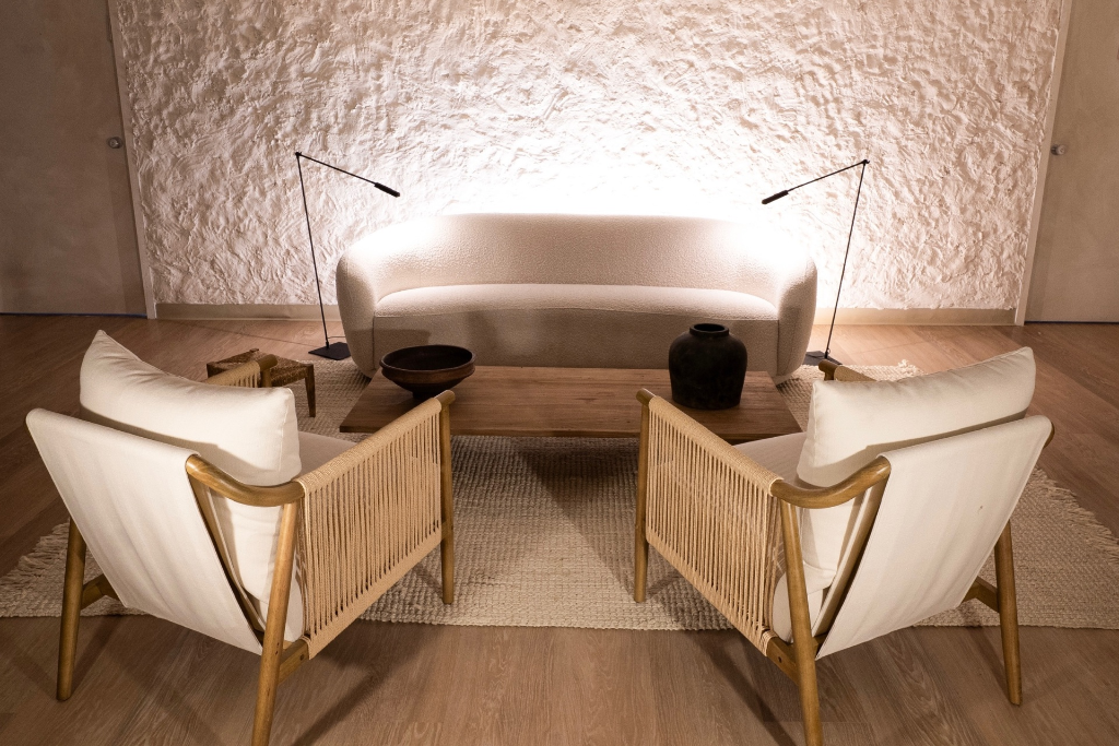 Shay Beauty Spa waiting area with curved bouclé sofa and textured wall