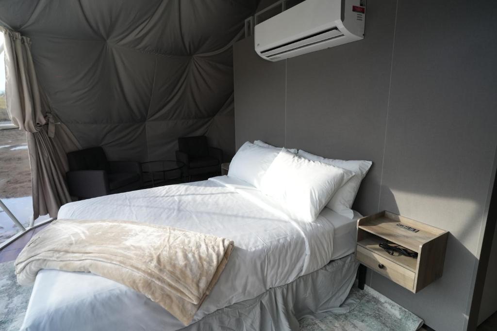 Bed and nightstand inside a dome