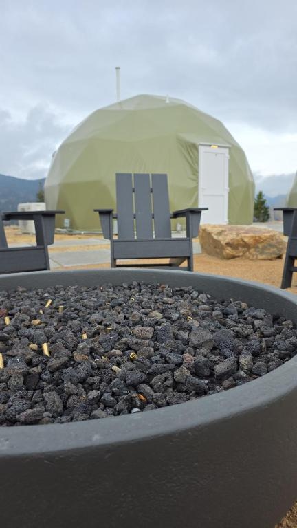 Fire pit and Adirondack chair outside a dome