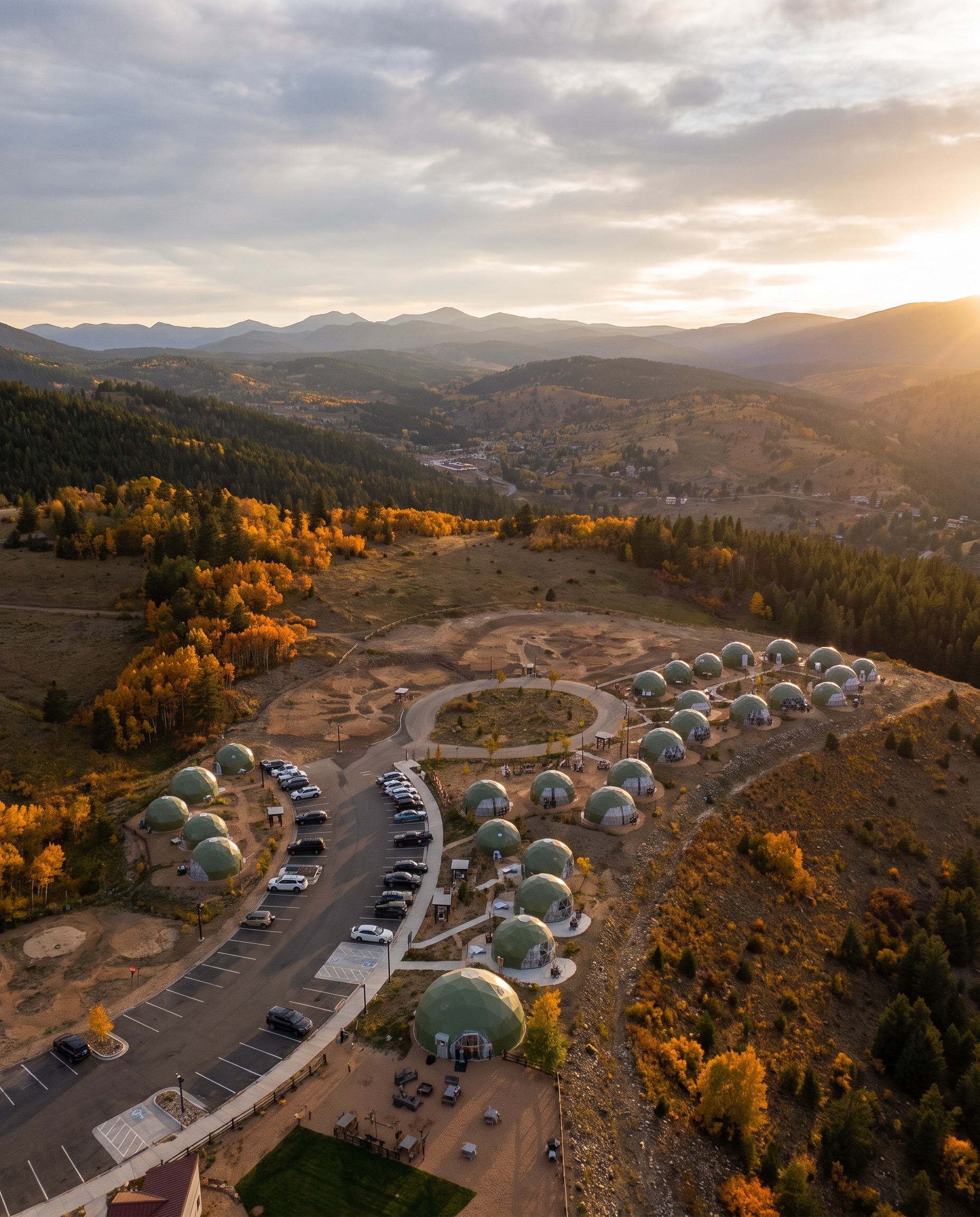 Drone view of the resort with parking and domes along the ridge