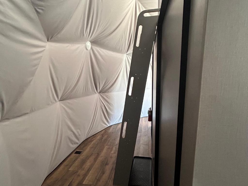 Tufted wall and loft ladder inside a dome