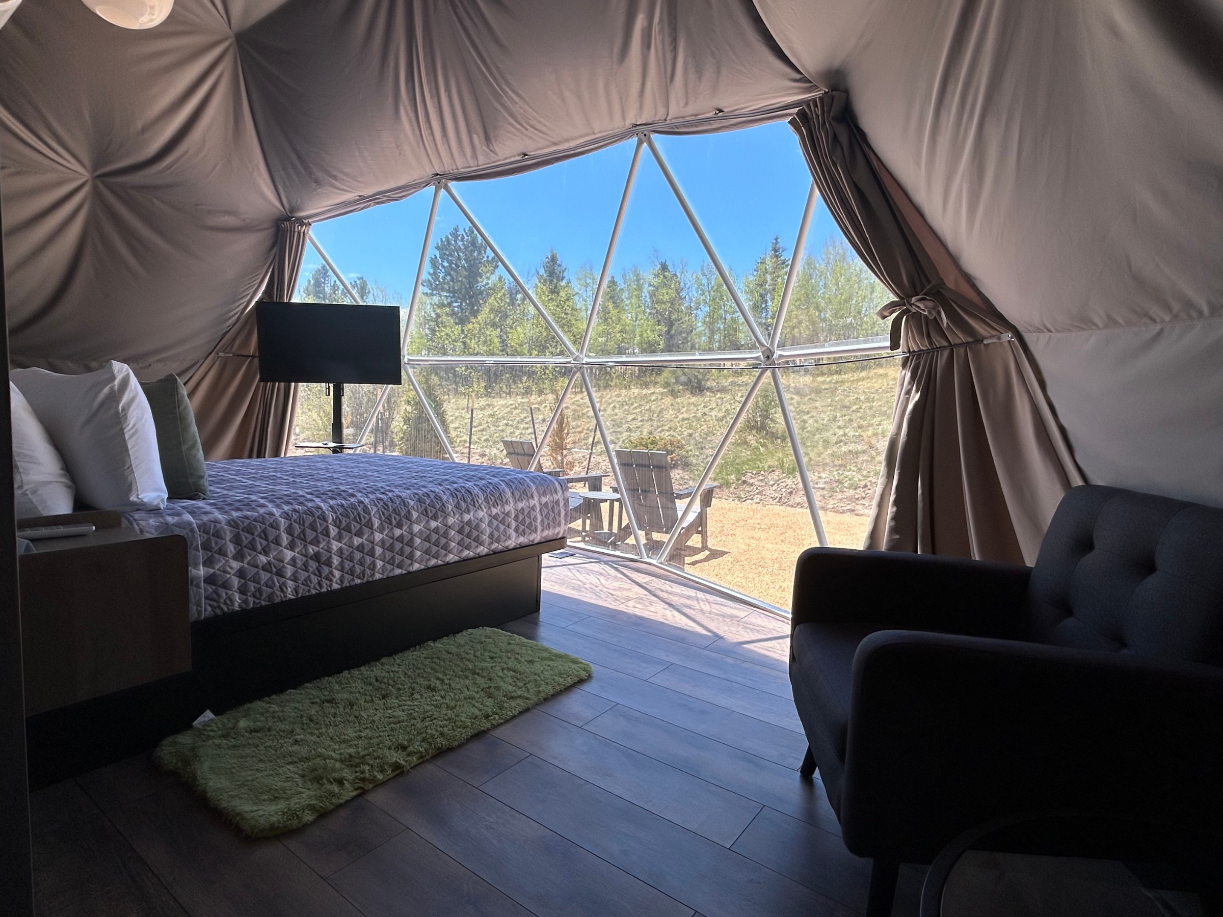 Wide interior view of the Deluxe Garden Views Dome with panoramic window