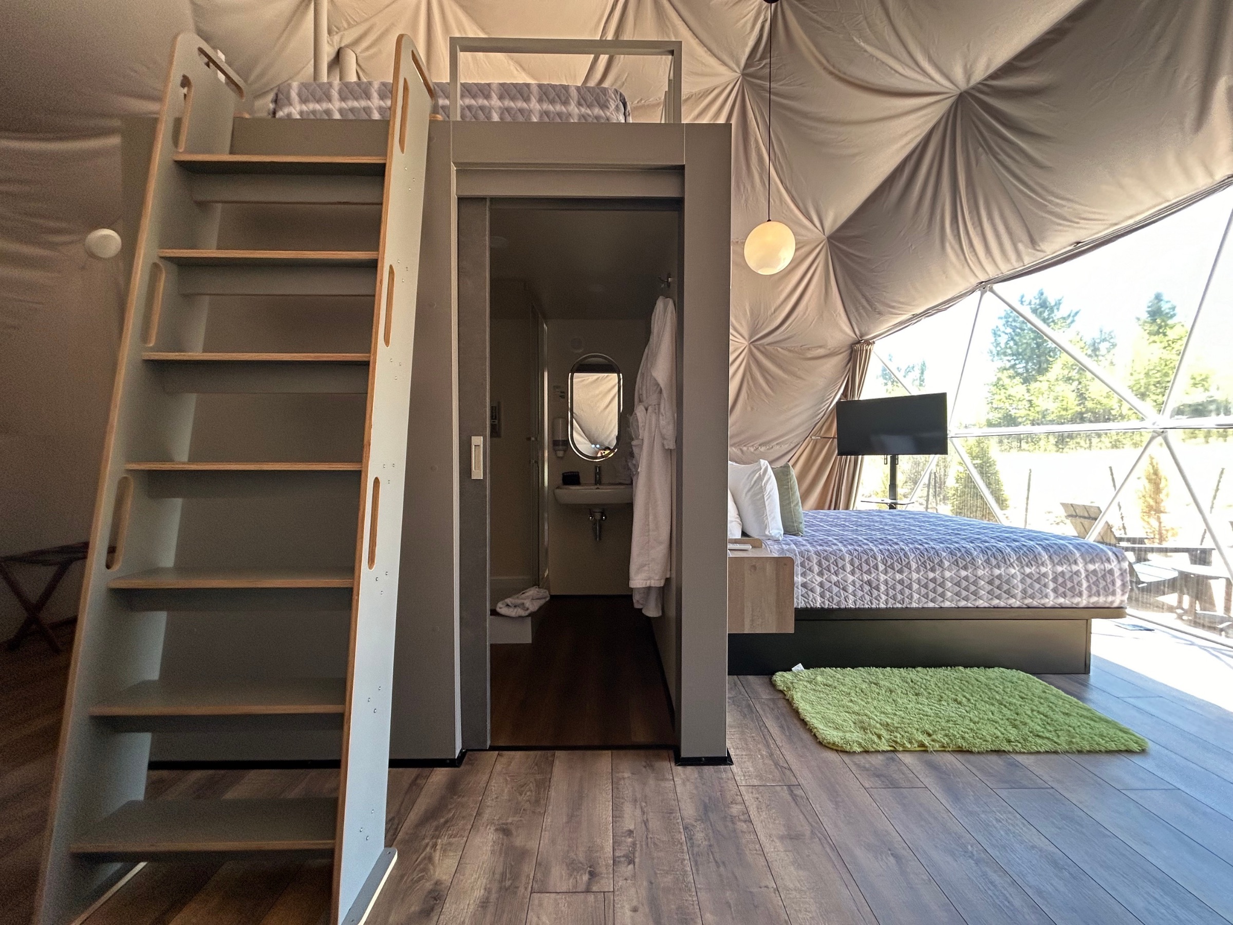 Loft staircase and enclosed bathroom inside a dome