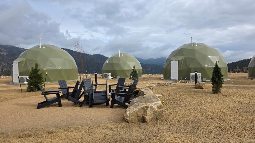 Three domes with outdoor seating and boulders