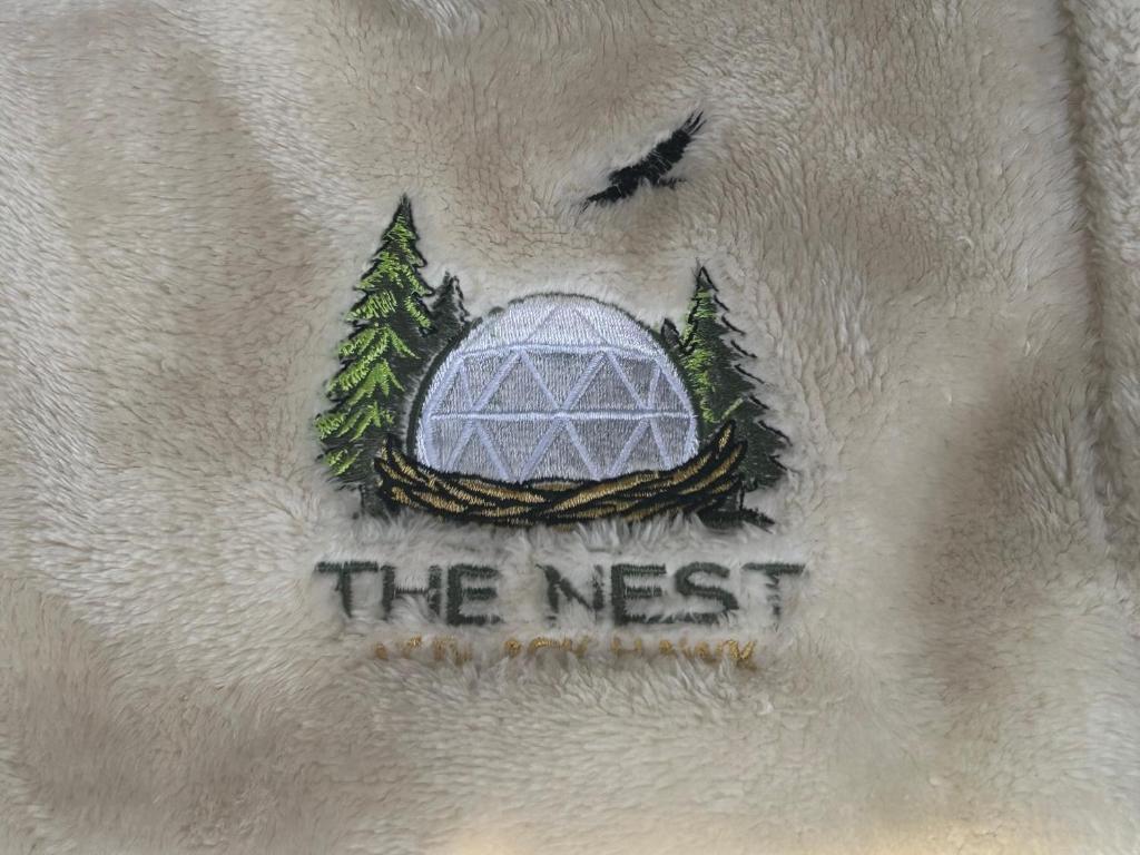 Embroidered The Nest logo on a dome blanket