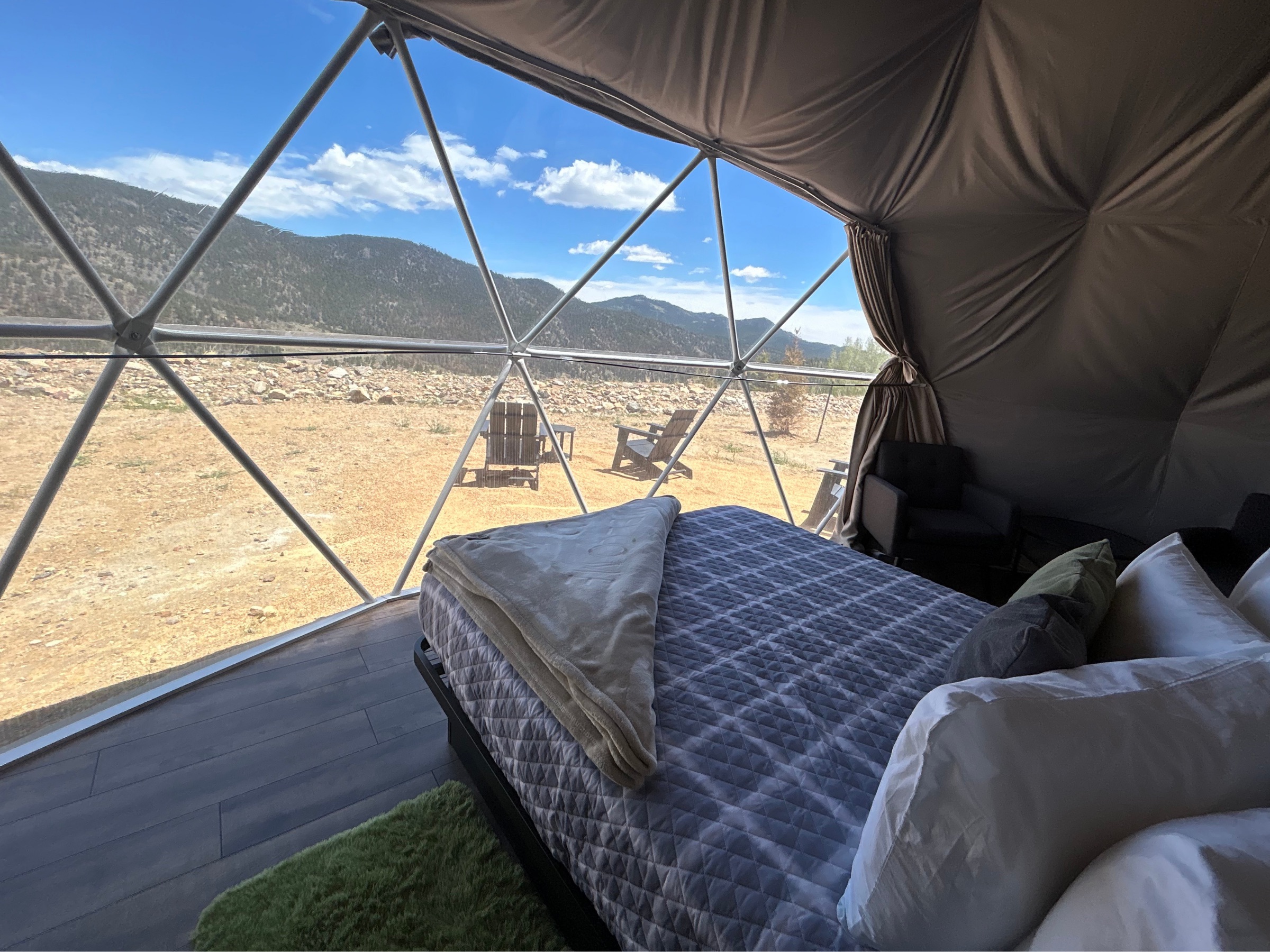 Bed and mountain view through the dome window