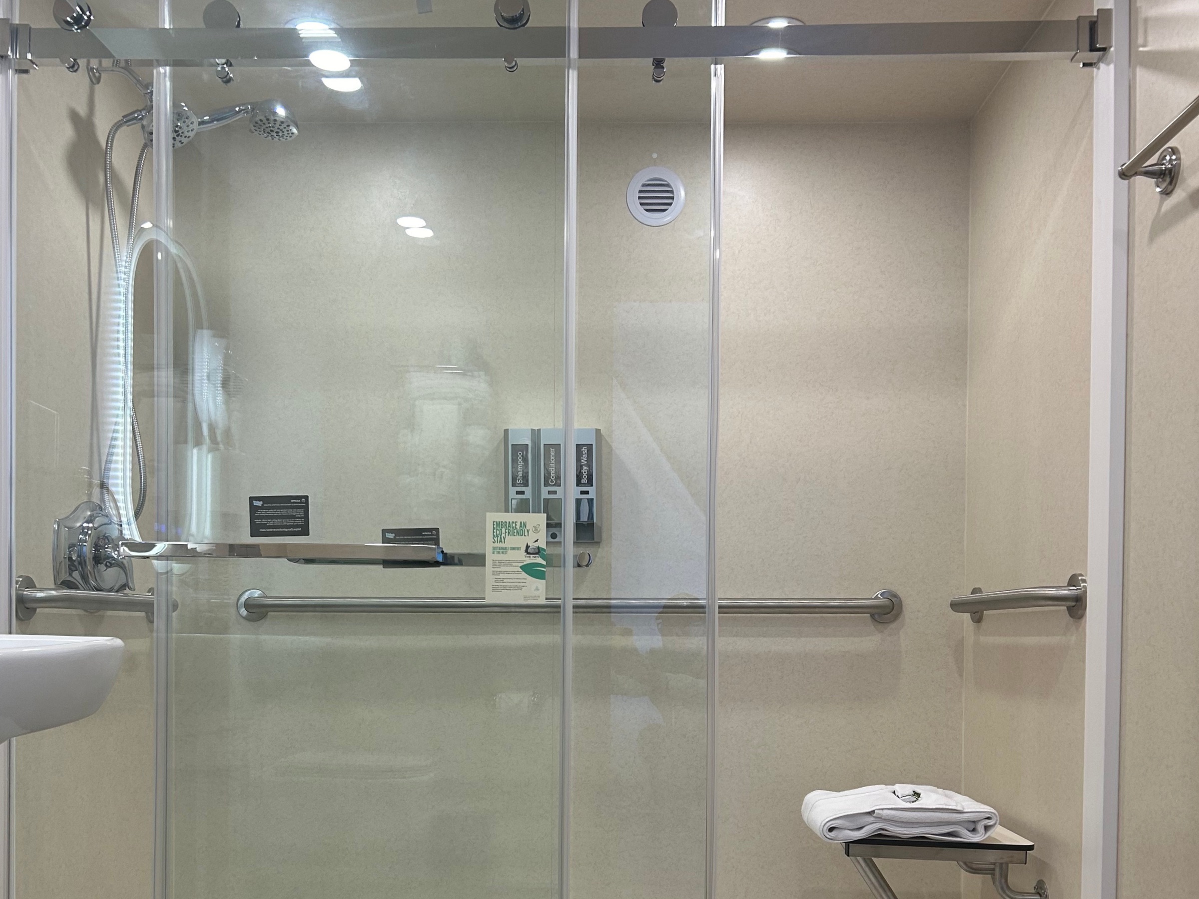 Accessible roll-in shower with fold-down seat
