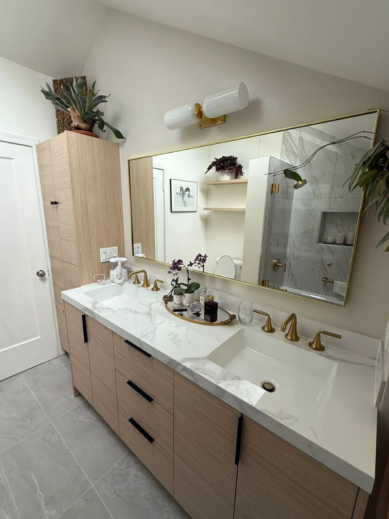 Double vanity bathroom with brass fixtures