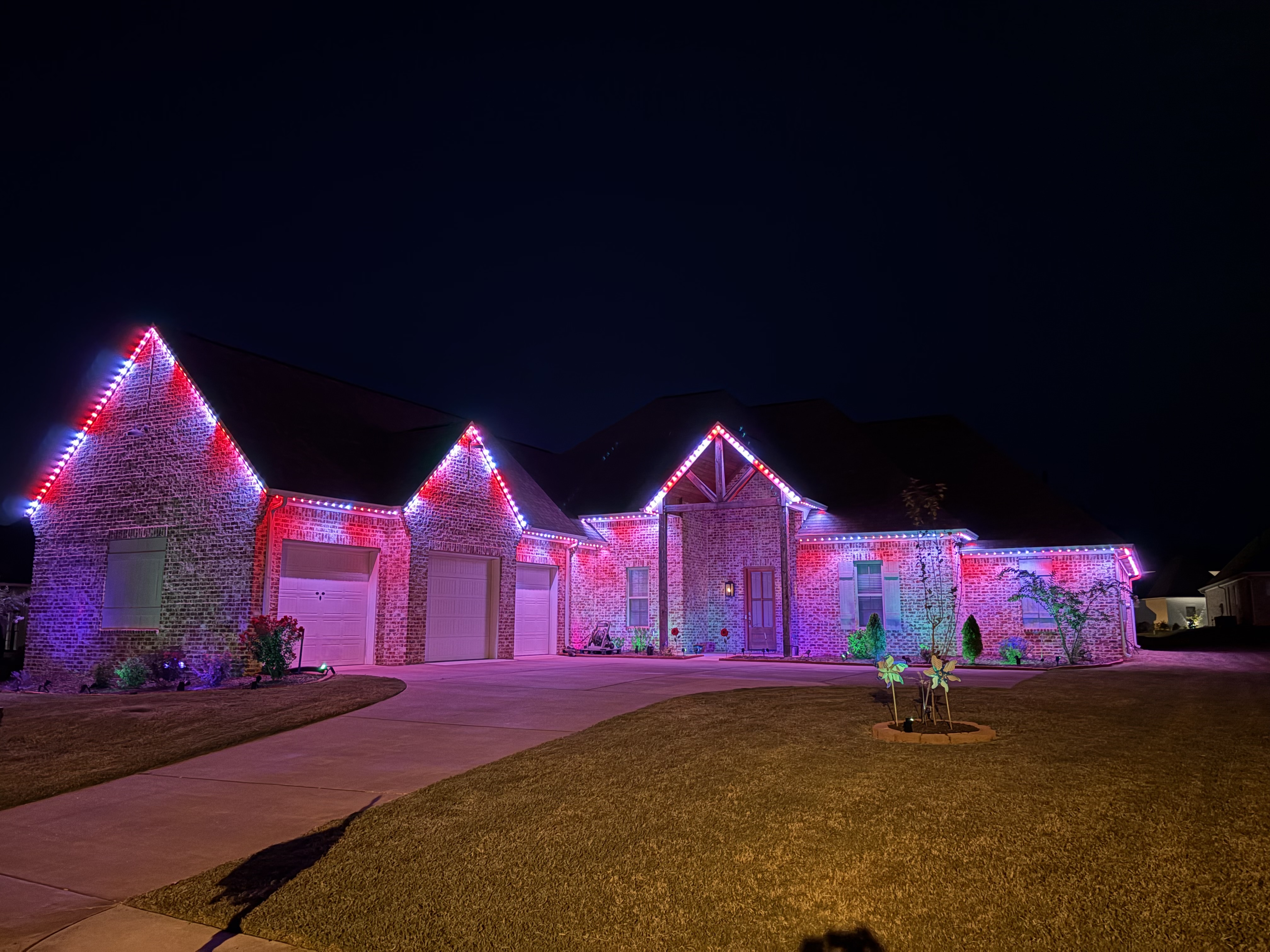 Brick home with red and blue game day LED lighting