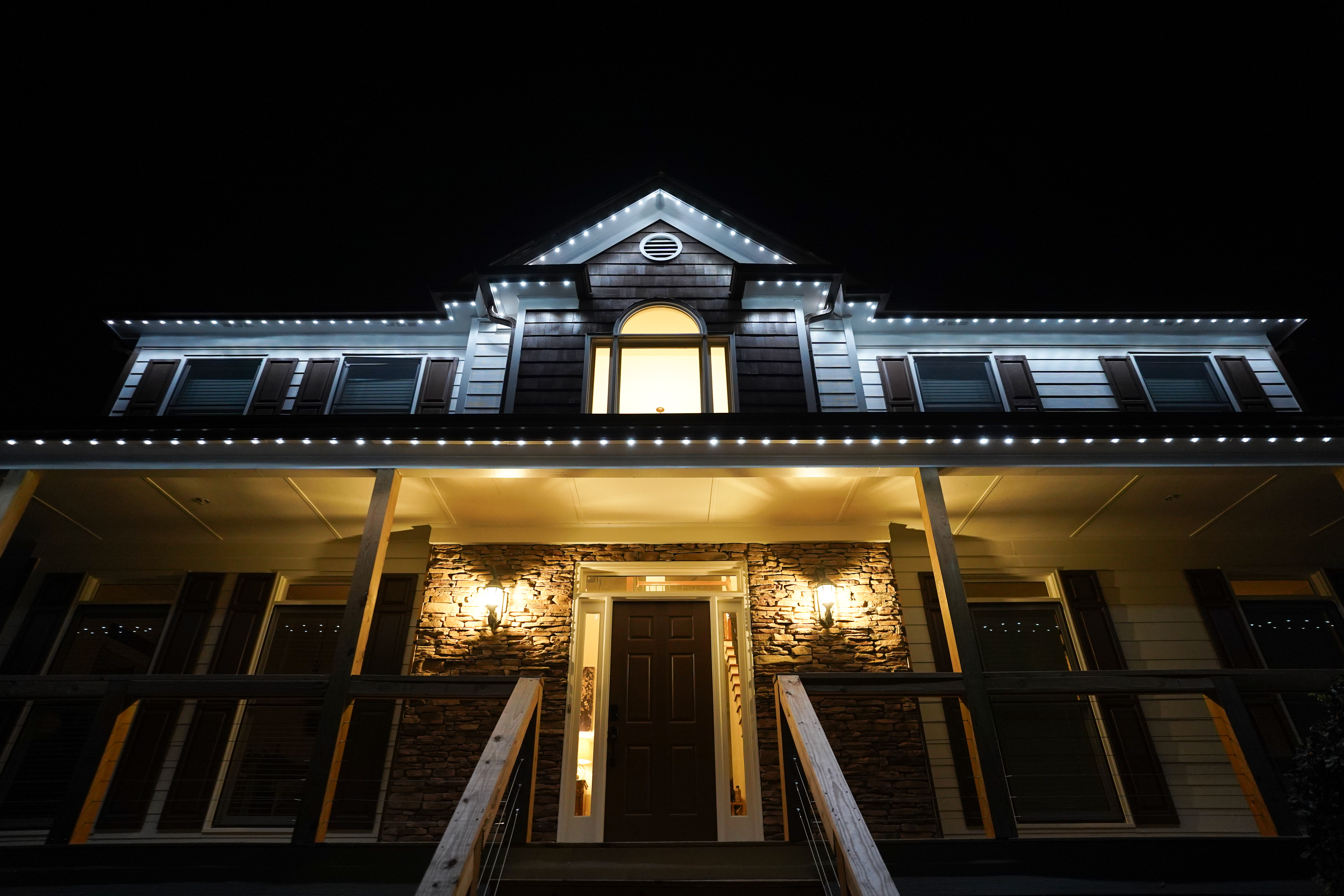 Home with white roofline security LED lighting