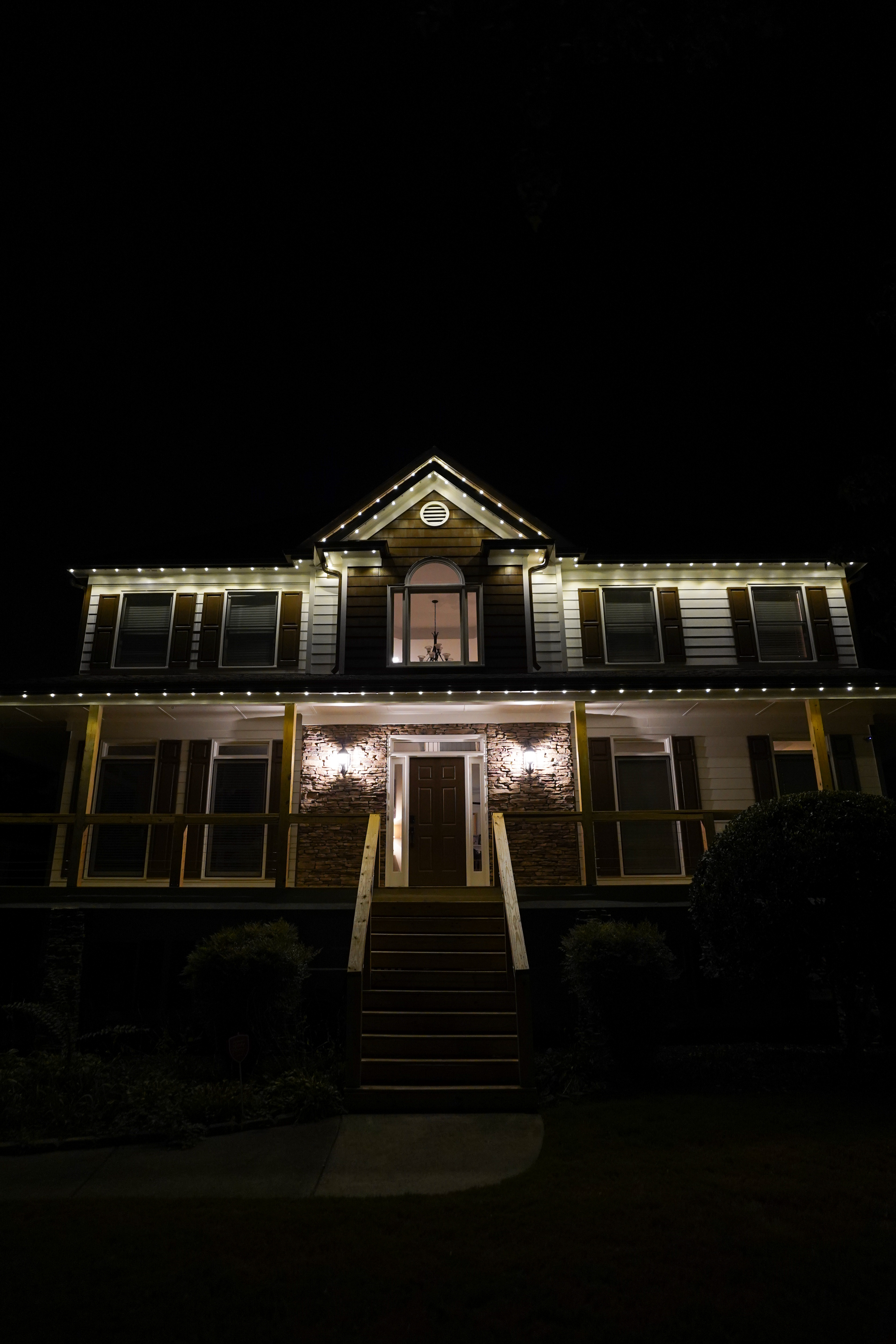 Home with white roofline accent LED lighting
