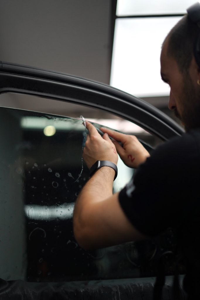 Professional ceramic window tint being applied to a vehicle at Opulent Detailing Epping