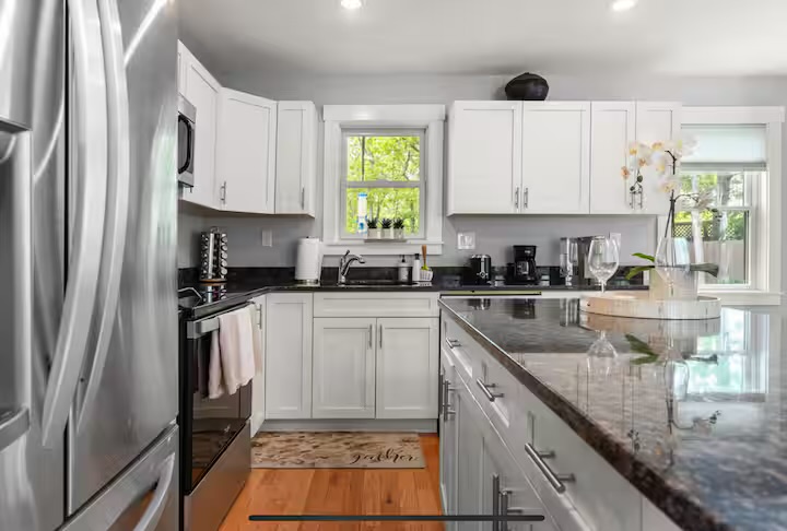 Fully equipped modern kitchen with marble countertops in the main house at Summer Wind