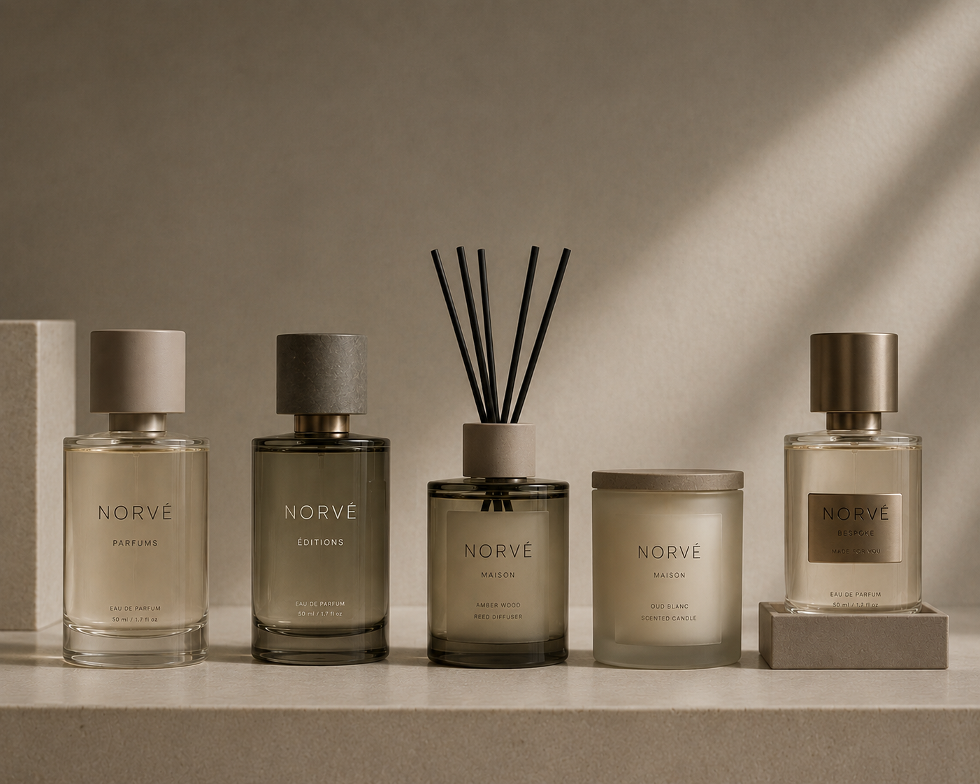 Five Norve fragrance and home scent products, including parfums, editions, reed diffuser, scented candle, and bespoke, arranged on a light stone surface