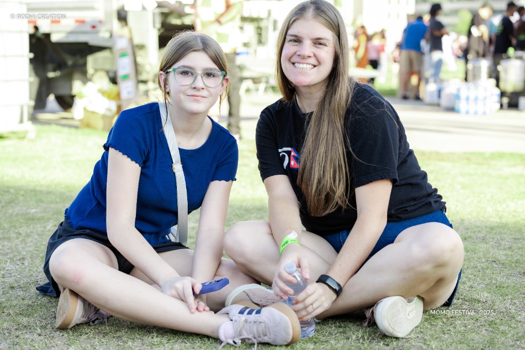 Two festival attendees relaxing on the lawn