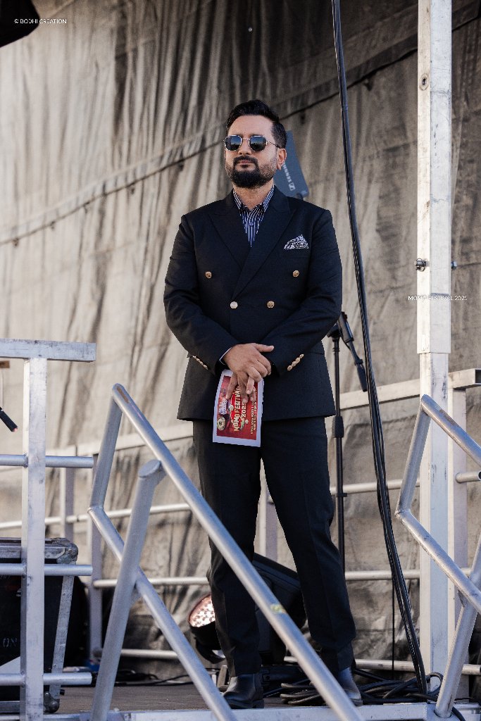 Performer on stage in a black suit