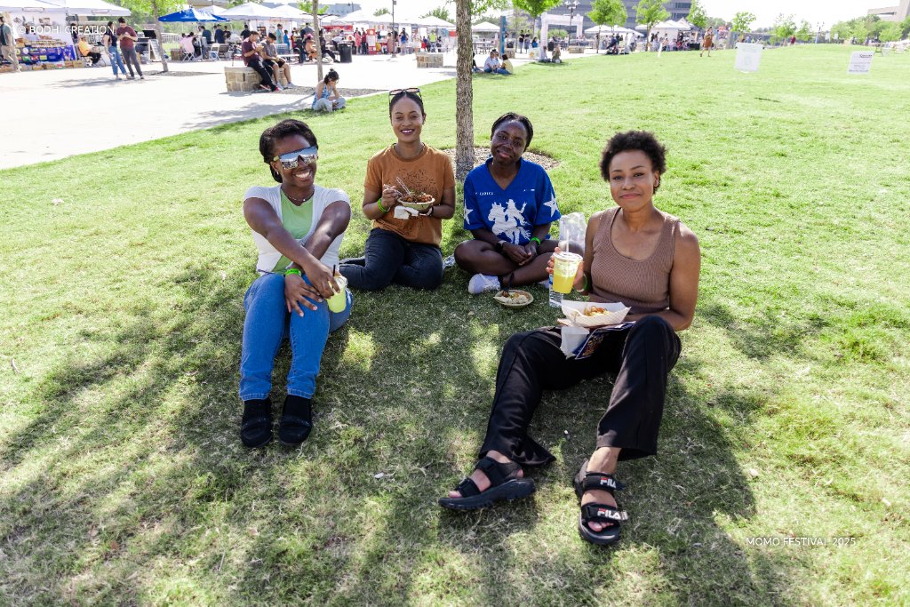 Festival attendees enjoying food on the grass