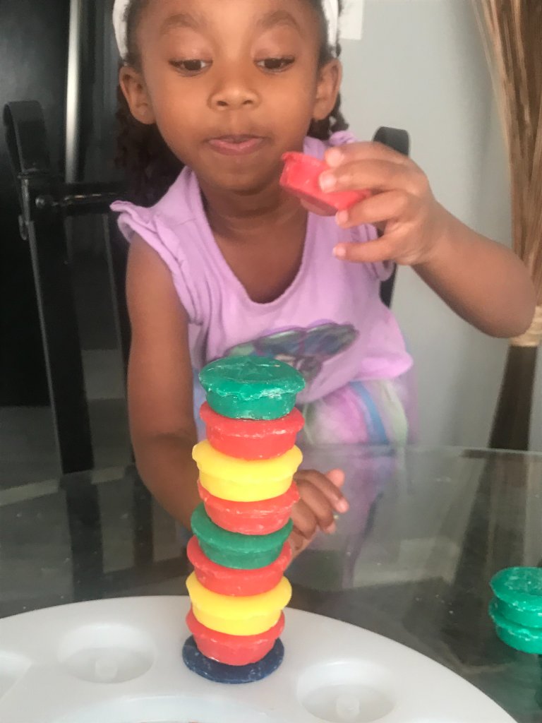 Girl placing a red disc on the stack