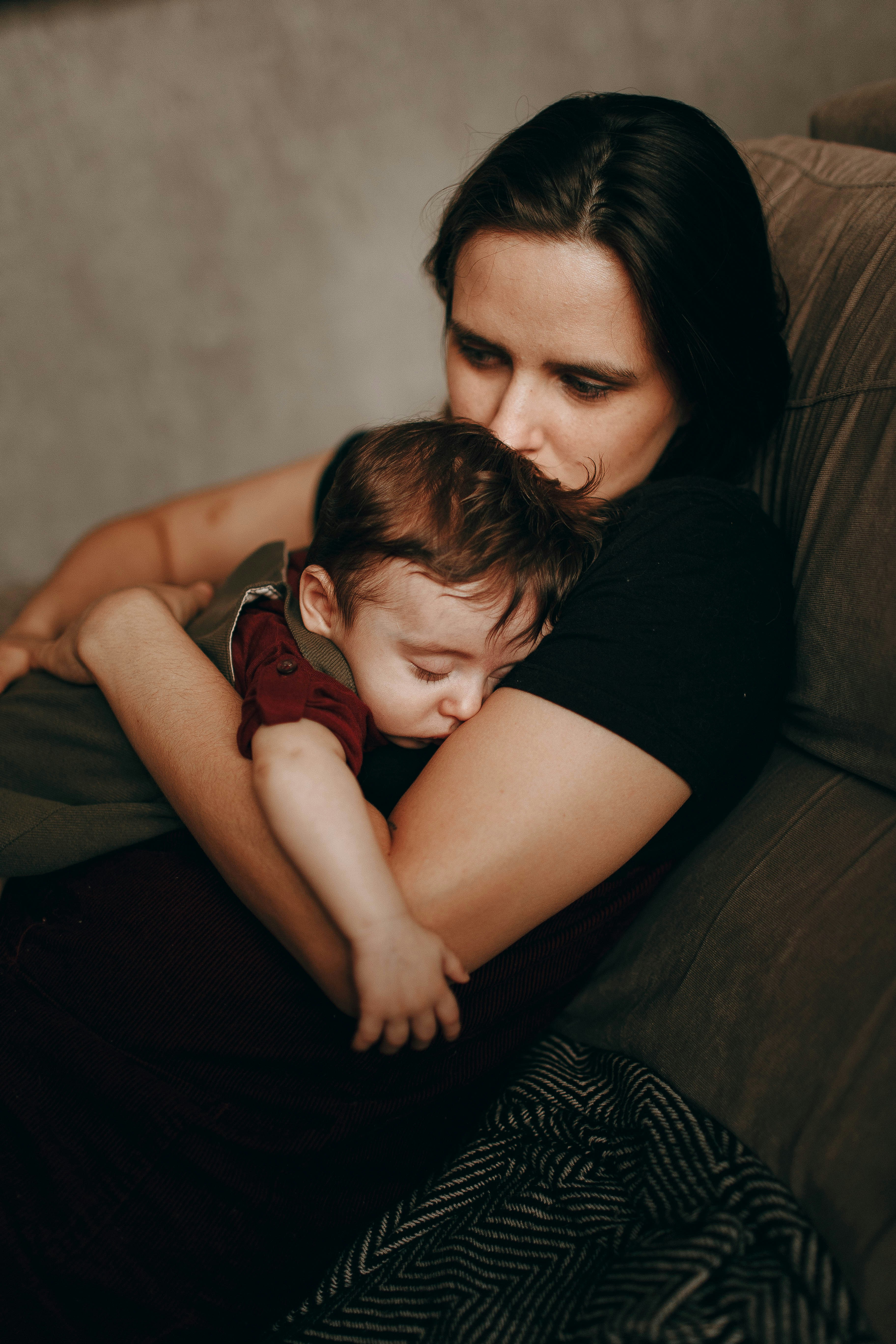 An exhausted parent sitting on the kitchen floor