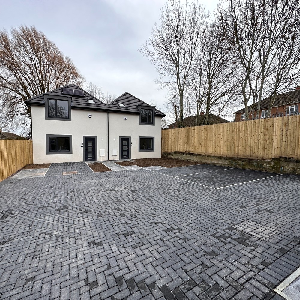 Semi-detached pair with marked parking bays.