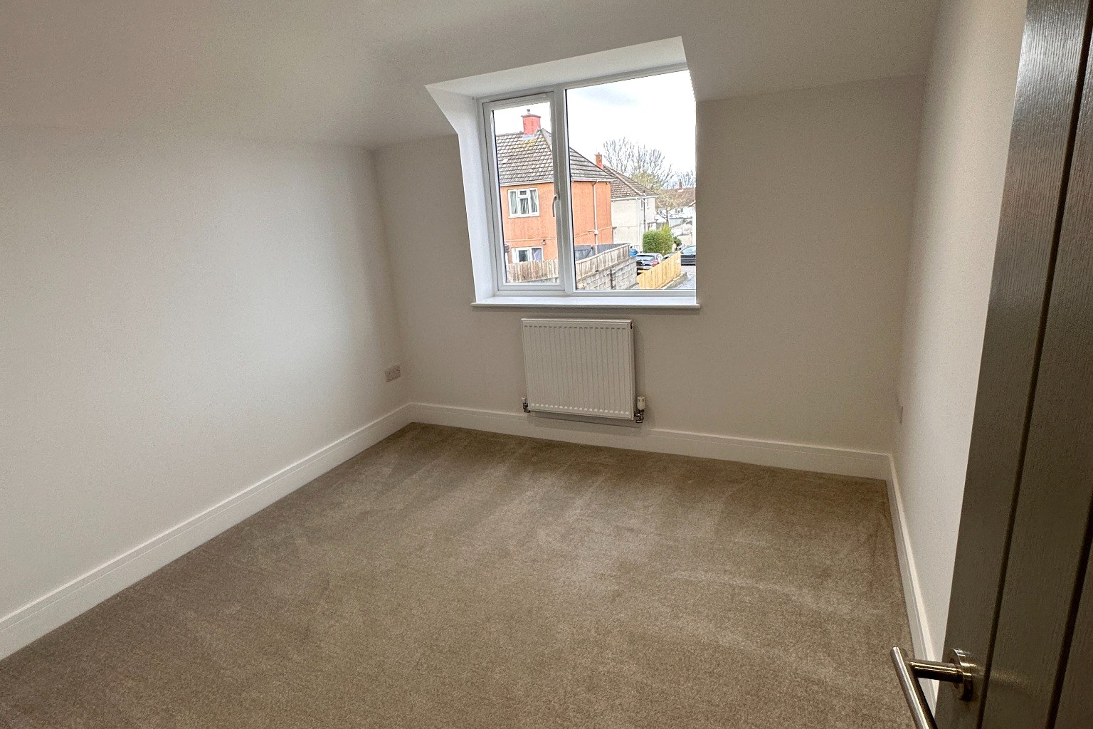 Bedroom with sloped ceiling and dormer.