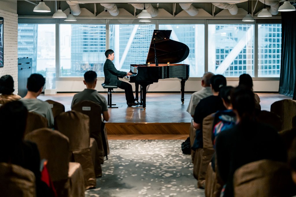 Wide shot — stage with urban skyline