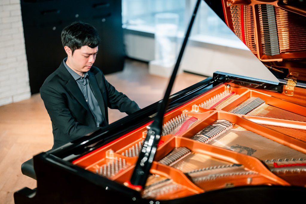 Close-up playing grand piano — bright interior