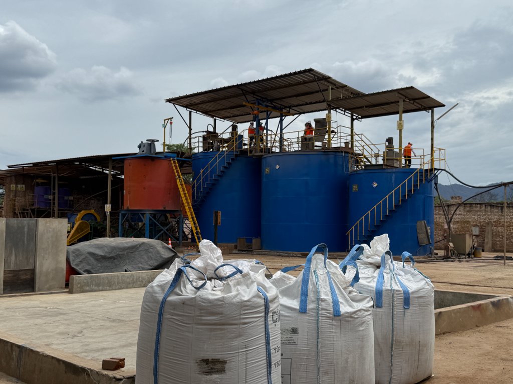 Las Lomas gold processing plant with blue and orange tanks, super sacks, and workers