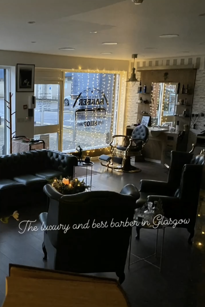 VIP Cut Barber interior with warm fairy lights, leather seating and barber station in Newton Mearns