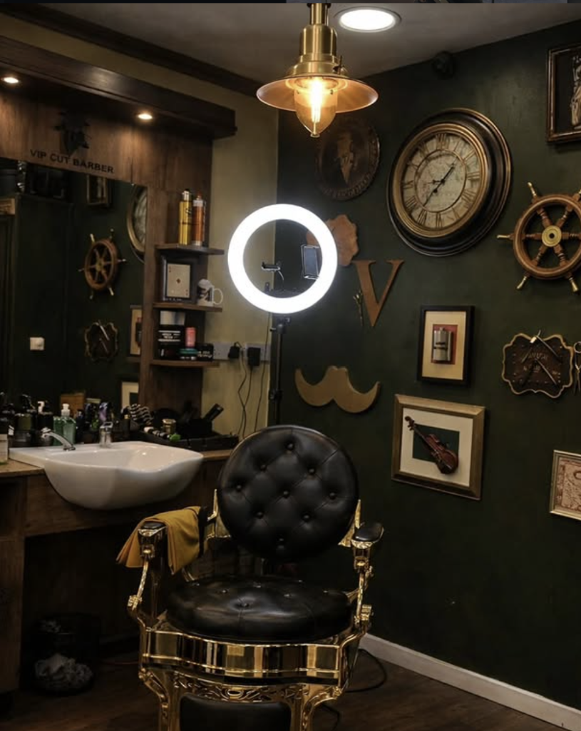 VIP Cut Barber station with gold-trim leather chair, forest green wall and vintage decor in Newton Mearns