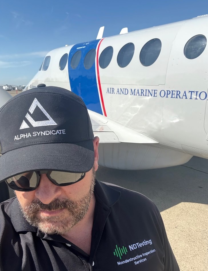 Founder in a branded Alpha Syndicate cap