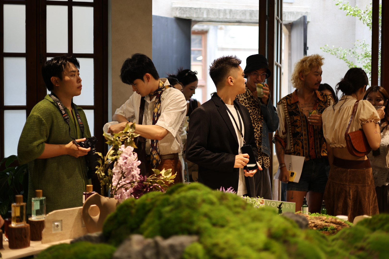 Guests in conversation by the open doors of the shikumen house