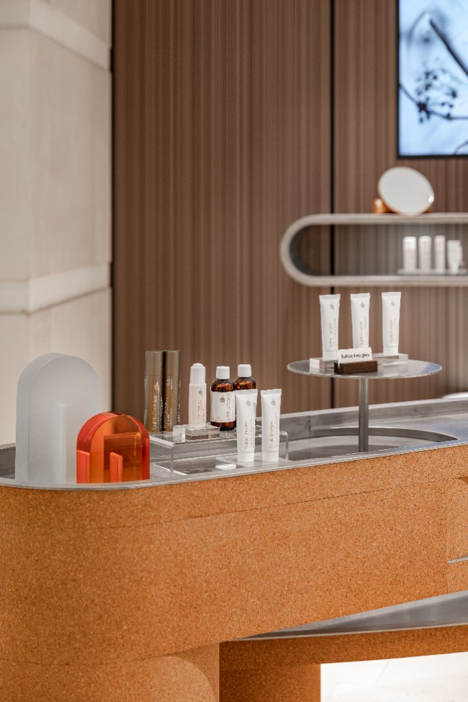 Skincare presented on a polished steel counter top