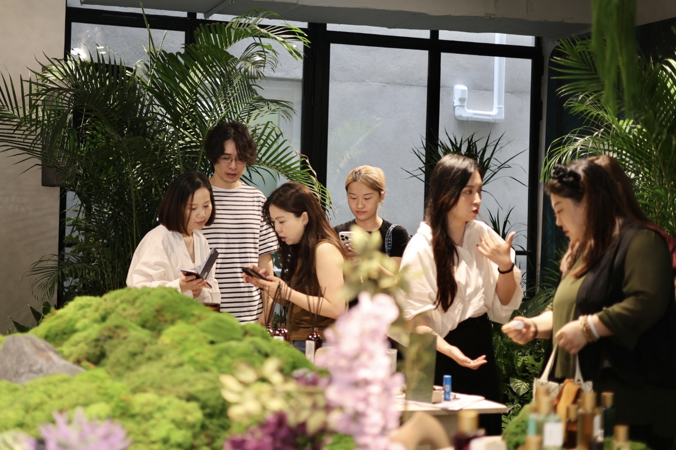 Visitors discovering the brands across the moss landscape