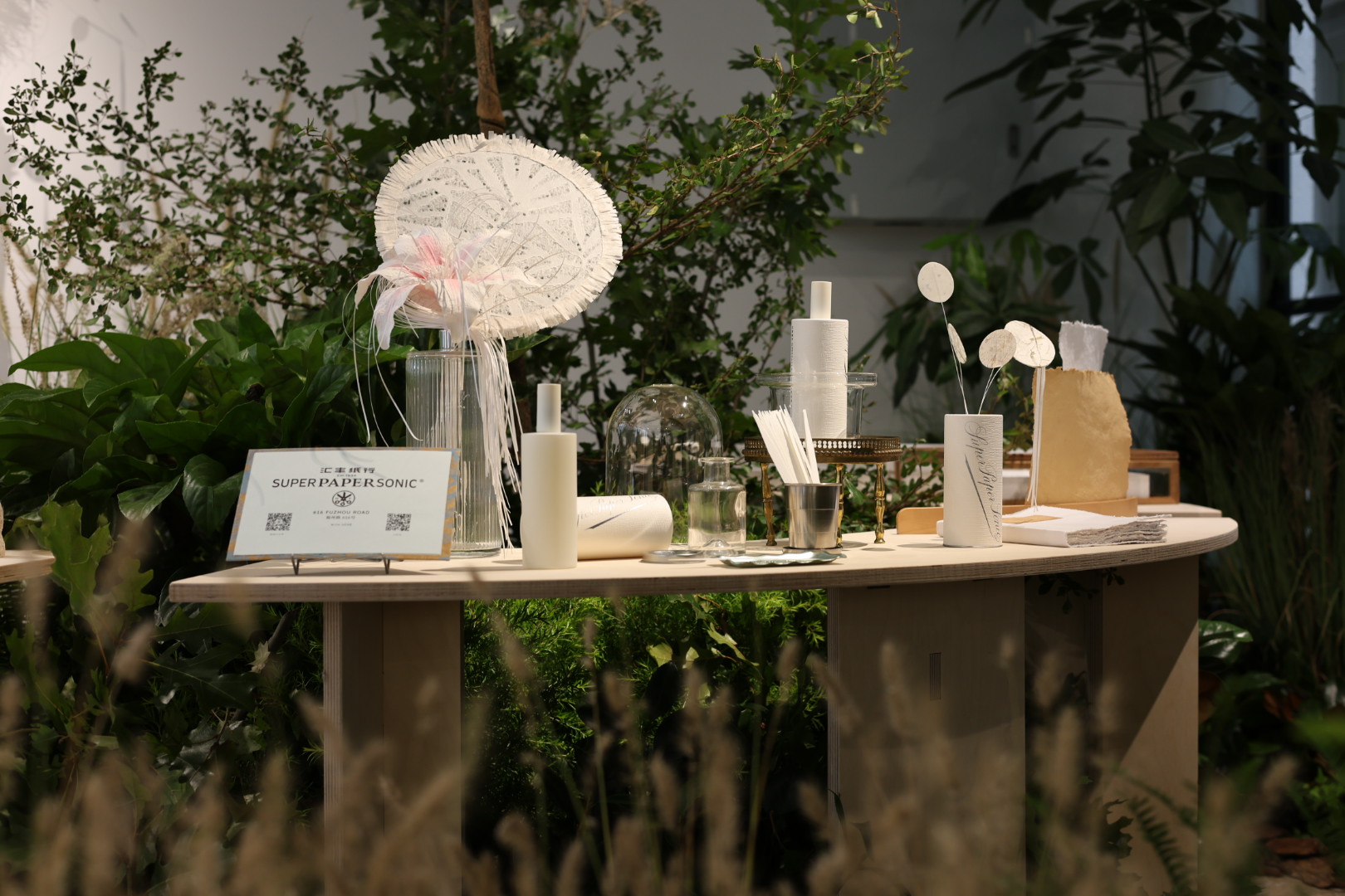 Super Paper Sonic presented as a still life among grasses and paper forms
